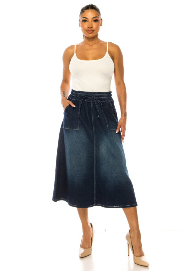 Woman wearing a white tank top and denim skirt on a white background